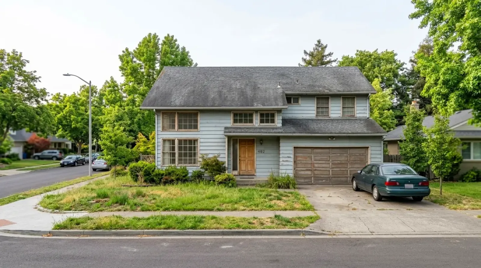 Dated suburban home exterior before whole-home renovation
