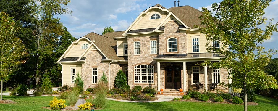 large stone house with yard