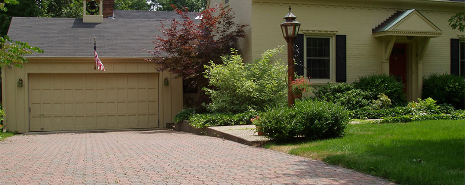 Driveway in front of Colonial house with pavers