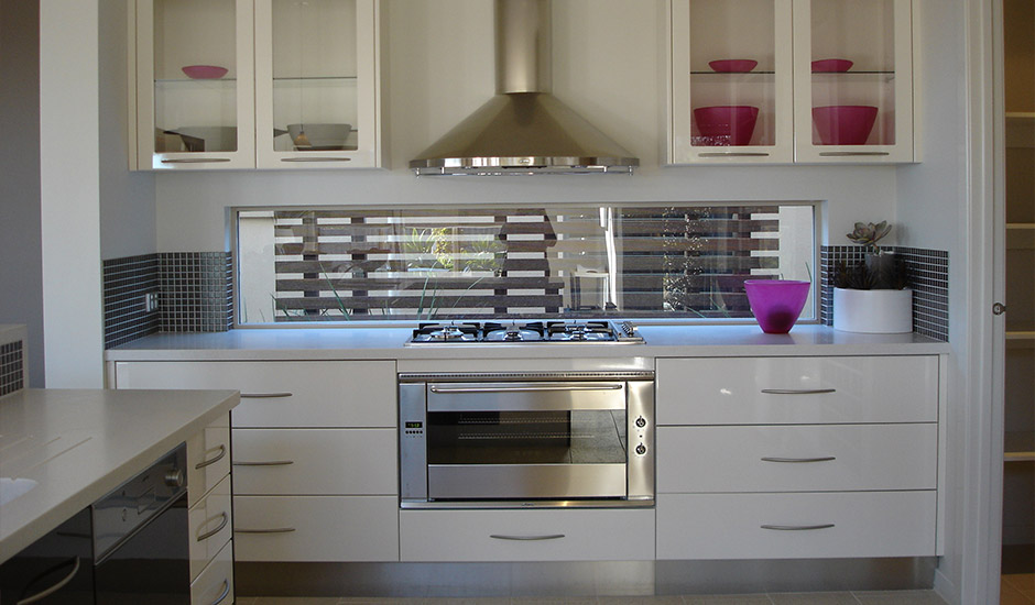 white modern kitchen with window behind stove