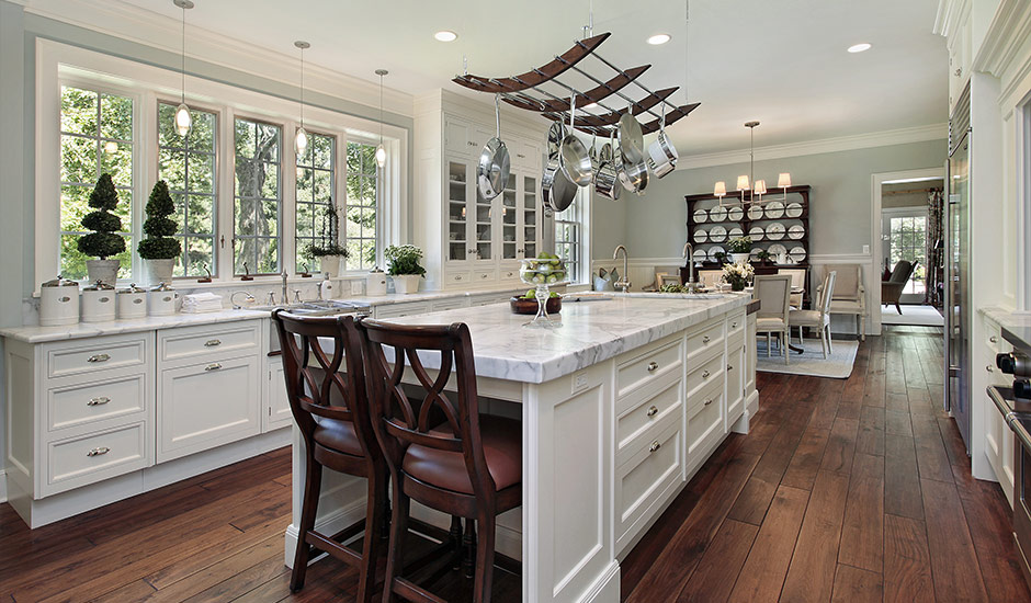 white marble kitchen with dark hardwood floors