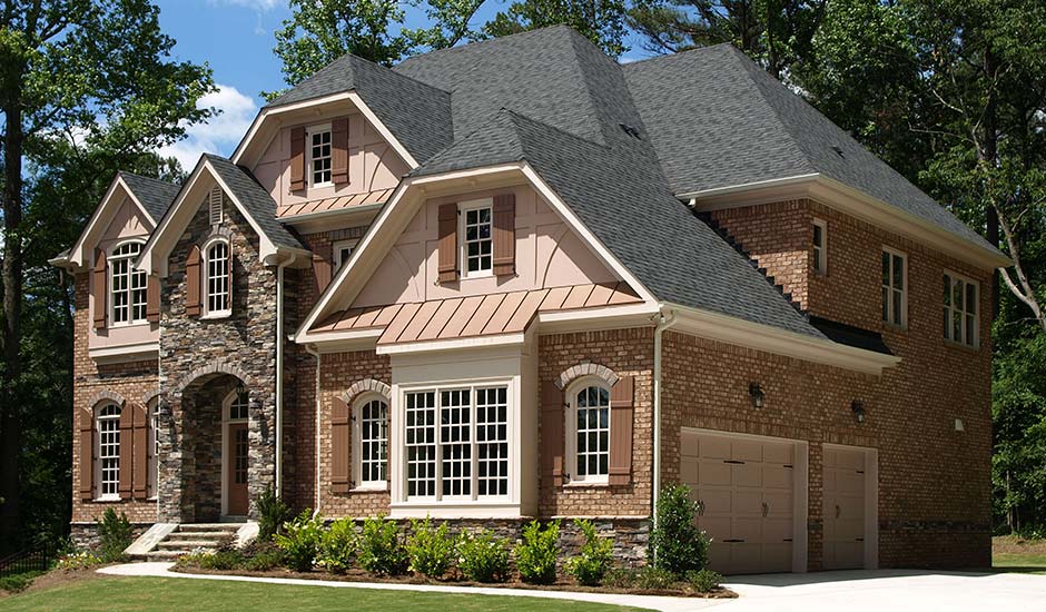 brick and stone luxury home with new roof
