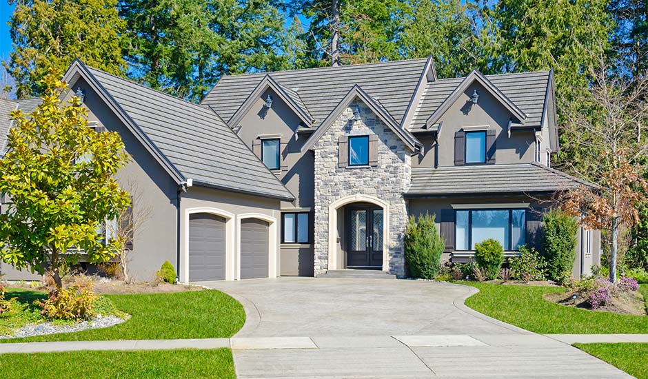 stone home with large driveway