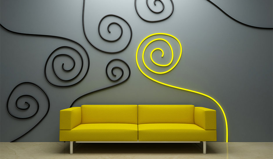 yellow couch and spiral wall art on grey wall