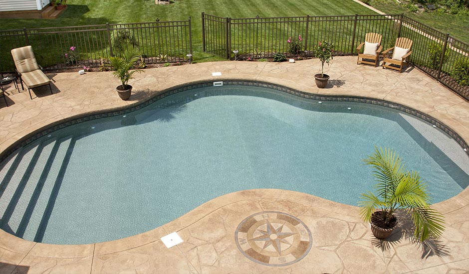 aerial view of backyard pool with decorative marble