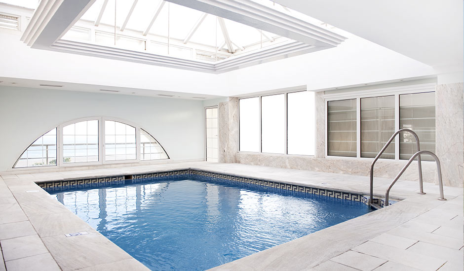 indoor home pool with white marble