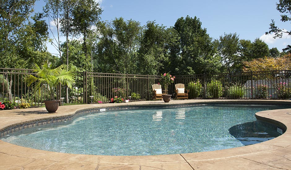 side view of backyard pool with decorative marble