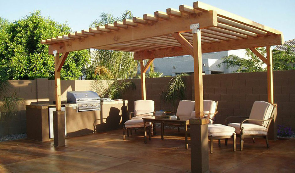 large pergola in backyard with BBQ